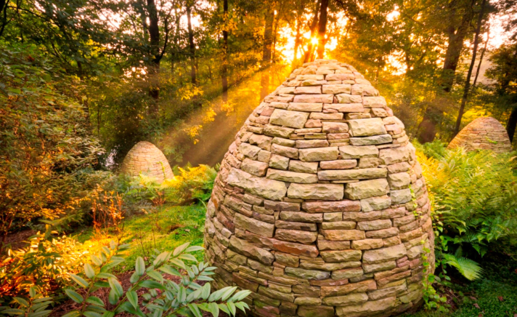 Commercial Landscape Architecture - Stone Sculpture with sunlight dispersed behind